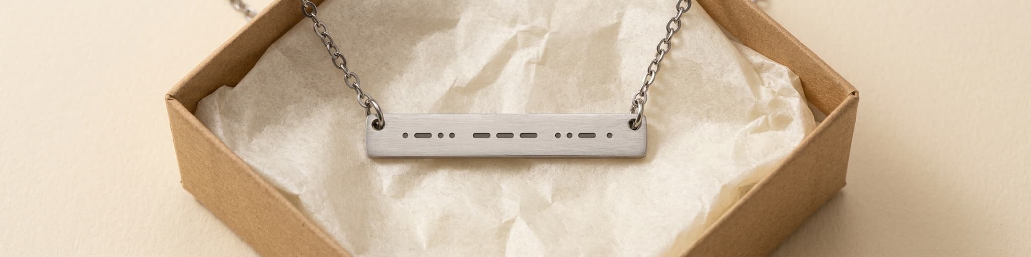 Morse code necklace in a kraft gift box with tissue paper